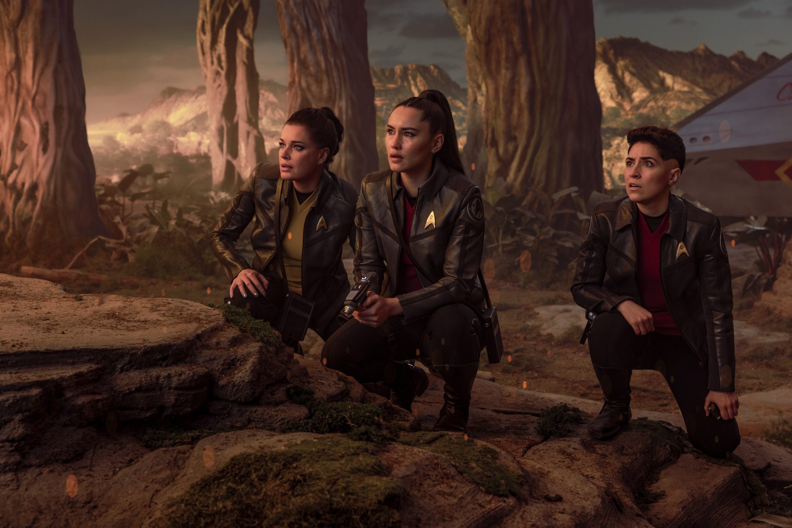 (L-R): Rebecca Romijn as Una, Christina Chong as La’an Noonien-Singh, and Melissa Navia as Erica Ortegas in season 4, episode 1, of Star Trek: Strange New Worlds